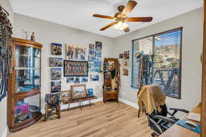 Office featuring ceiling fan and light hardwood / wood-style floors