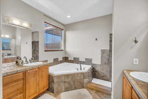 Bathroom featuring vanity, plus walk in shower, and tile patterned flooring