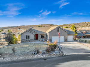 Single story home featuring a garage and a mountain view