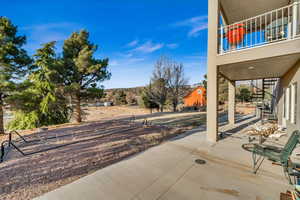 View of patio featuring a balcony