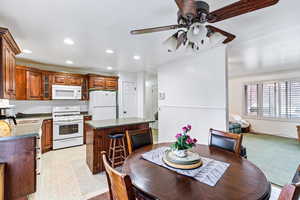 Dining area, ornamental molding, and ceiling fan