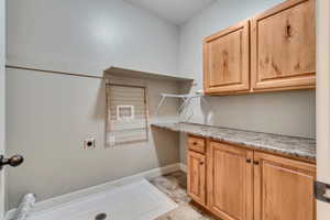 Washroom featuring cabinets and electric dryer hookup