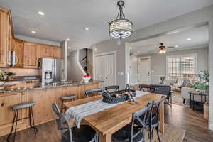 Dining space with sink, dark wood-type flooring, and ceiling fan