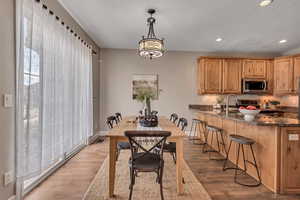 Dining room with sink and light hardwood / wood-style flooring