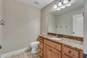 Bathroom featuring vanity and toilet