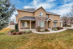 View of front of home featuring central AC and a front yard