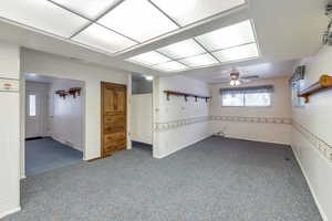 Basement featuring carpet floors and ceiling fan