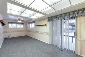 Carpeted empty room with ceiling fan