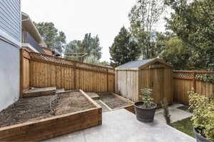 View of patio with a storage unit