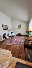 Sitting room with hardwood / wood-style floors and vaulted ceiling