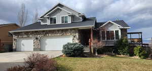 View of front of house with a garage and a front yard