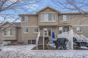 View of snow covered rear of property