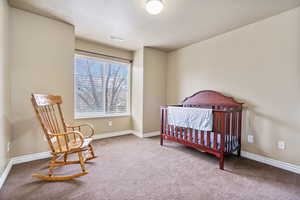 Bedroom featuring carpet and a textured ceiling