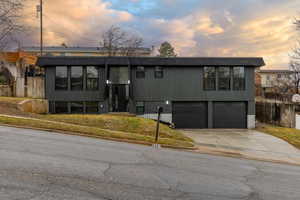 View of front of home featuring a garage and a lawn