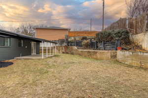 Yard at dusk featuring a patio