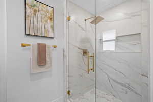 Bathroom with a shower with shower door