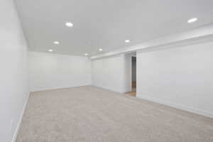 Carpeted empty room featuring a textured ceiling