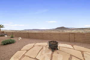 View of patio / terrace featuring an outdoor fire pit and a mountain view