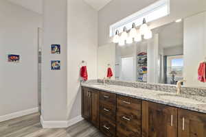 Bathroom with hardwood / wood-style flooring, vanity, and an enclosed shower