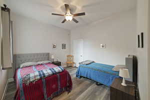 Bedroom featuring wood-type flooring and ceiling fan