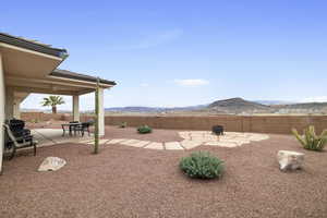 View of yard with a mountain view, a patio area, and a fire pit