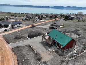Birds eye view of property with a water and mountain view