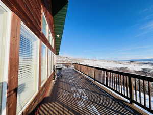View of snow covered back of property