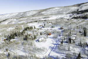 Snowy aerial view featuring a mountain view