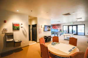 Carpeted dining room with french doors