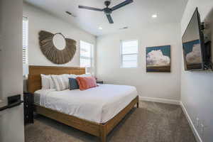 Carpeted bedroom featuring ceiling fan