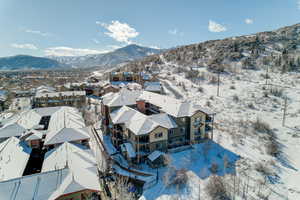 Snowy aerial view featuring a mountain view