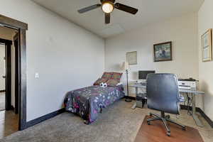 Bedroom featuring ceiling fan and carpet