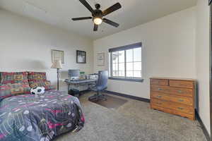 Bedroom featuring ceiling fan and carpet