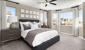 Carpeted bedroom with multiple windows and ceiling fan