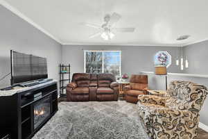 Living room with crown molding and ceiling fan