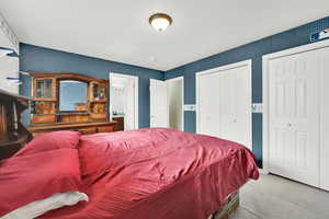 Bedroom featuring ensuite bathroom, carpet, sink, and a closet