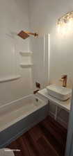 Bathroom with sink, hardwood / wood-style floors, and shower / bathtub combination