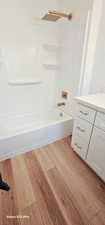 Bathroom featuring vanity, hardwood / wood-style floors, and shower / bathing tub combination