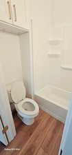 Bathroom with wood-type flooring and toilet