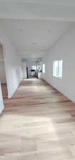 Spare room featuring lofted ceiling and light hardwood / wood-style floors