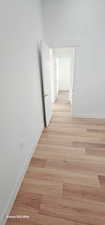 Hallway with light hardwood / wood-style floors