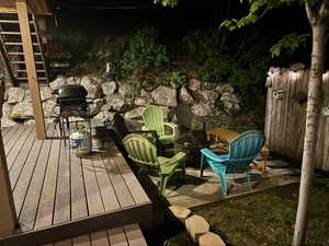 Wooden deck featuring a fire pit