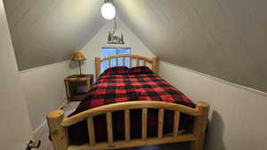 Furnished Upstairs Bedroom with vaulted ceiling and carpet