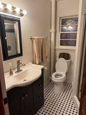 Bathroom with walk in shower, vanity, and toilet