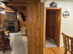 Hallway with wooden walls and light wood-type flooring