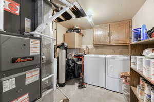 Clothes washing area with cabinets, washing machine and dryer, and heating unit