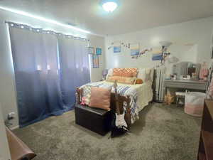 Bedroom featuring a textured ceiling and carpet flooring