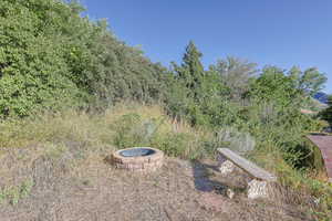 View of yard featuring an outdoor fire pit