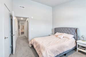 Bedroom featuring light colored carpet