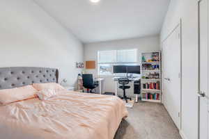 Bedroom with light carpet and a textured ceiling